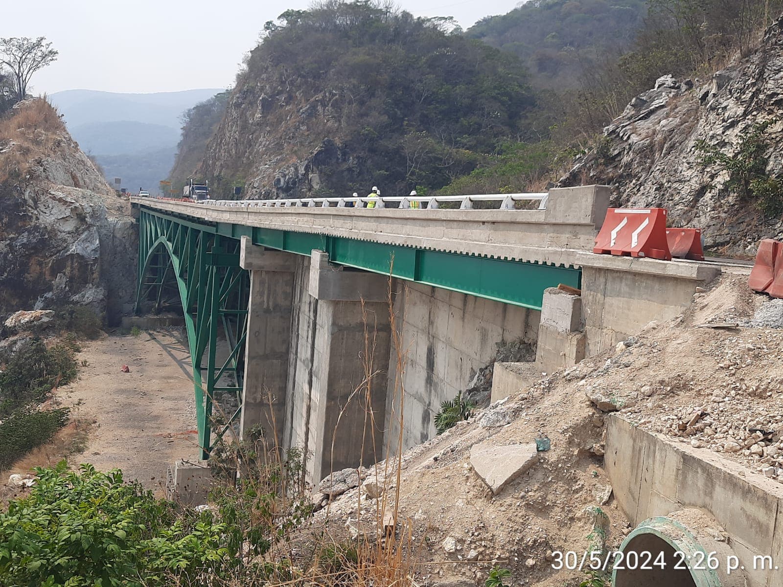 Puente en construcción sobre un cañón con personal de obra